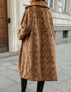 Detailed texture of long faux fur coat with bold snake skin pattern and soft plush finish