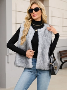 Outdoor street shot of a grey long-hair faux fur vest with a stylish V-neck sleeveless design