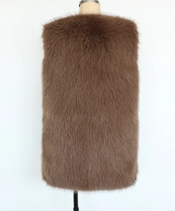Detail view of the thick long-haired dark brown faux fur vest on a studio mannequin