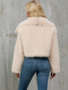Back view of a beige faux fur jacket with fluffy texture and oversized collar