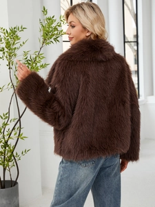 Detail view of the back and texture of a premium brown faux fur cropped jacket