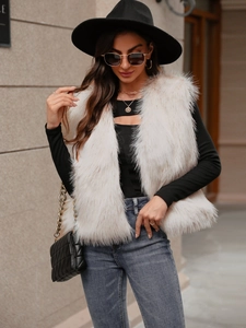 Chic beige faux fur vest styled with black turtleneck and hat for a trendy autumn look