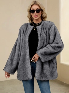 Detail of soft grey-blue faux fur coat texture and relaxed fit styling on a model