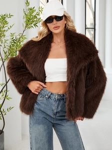 Detail of luxurious dark brown faux fur texture and large lapel collar on short jacket