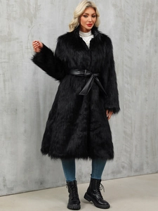 Detail of long black faux fur coat with leather waist tie and soft plush texture