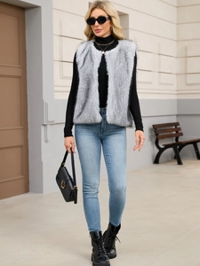 Faux fur vest in light grey styled with black turtleneck and high-rise jeans