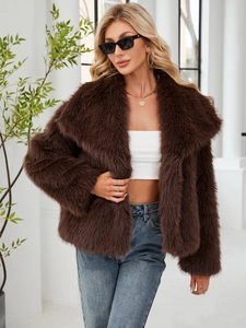 Detailed texture of dark brown faux fur jacket with wide lapels and soft plush finish