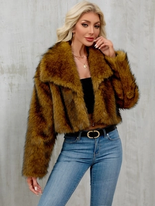 Detail of faux fur coat featuring wide lapels and soft fluffy brown texture texture