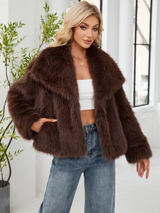 Detailed texture of women's short faux fur coat with oversized lapels in dark brown