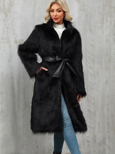 Detail view of long black faux fur coat with leather belt and plush texture detail