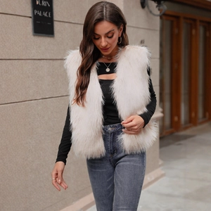 Detail shot of the long fluffy faux fur vest in light beige pink with an open-front design