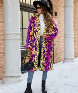 Detailed texture of vibrant purple and neon yellow faux fur leopard coat in street scene