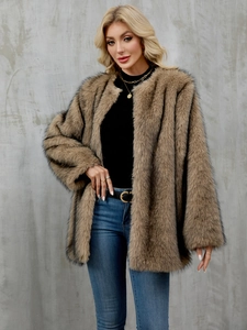 Close-up of light brown faux fur coat with black tips and plush fluffy texture details