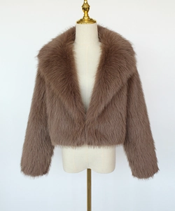 Detail view of deep beige cropped faux fur jacket with wide lapels and plush texture