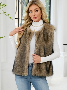 Detail shot of a brown faux fur V-neck vest styled with a white turtleneck and jeans