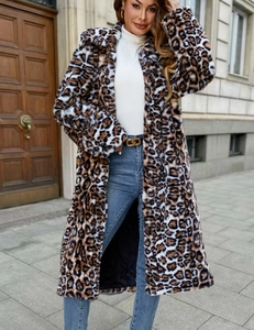 Outdoor street view of long faux fur coat with leopard print and a thick fluffy texture