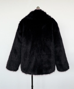 Back view of a black faux fur jacket with long plush texture on a display stand