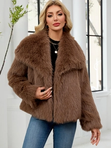 Detailed view of women's brown faux fur coat with large lapels and plush texture