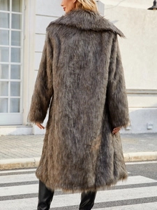 Macro detail of long dark brown faux fur coat showing thick plush texture and back silhouette