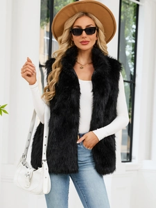 Faux fox fur vest in black mid-length style for women shown on a model outdoors