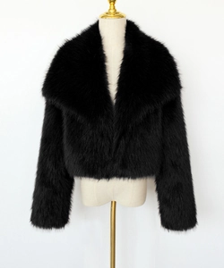 Detailed view of black faux fur jacket texture featuring wide collar and plush material