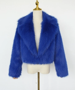 Detailed close-up of the plush faux fur texture and lapel design on the royal blue jacket
