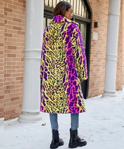 Close-up of fluffy leopard faux fur texture in vibrant purple and neon yellow colors