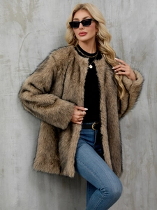 Detailed macro view of the fluffy faux fur texture on a thick beige winter cardigan