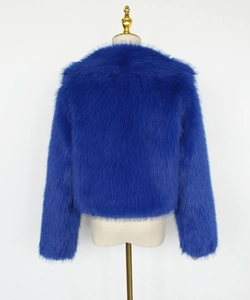 Macro detail of the plush faux fur texture on the electric blue cropped jacket