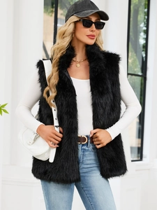 Women's faux fox fur vest in black featuring a long sleeveless design and fluffy texture