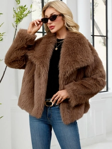 Detail of a plush brown faux fur jacket with a large lapel and soft textured finish