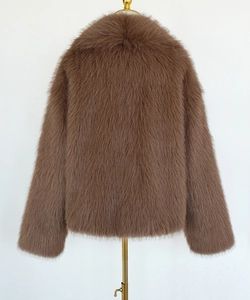 Detail showing the thick texture and soft touch of the brown faux fur oversized jacket