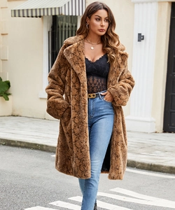 Close-up detail of luxury faux fur coat with realistic brown python snake skin pattern texture