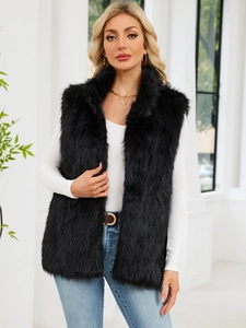 Close-up of fluffy black faux fox fur vest with a high collar on a female model