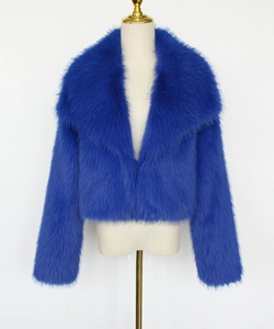 Detail of royal blue faux fur coat showing plush texture and oversized lapel design