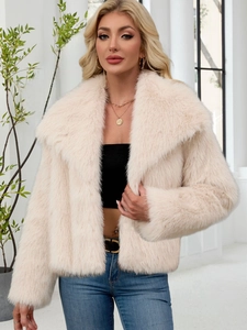 Detailed close-up of fluffy cream faux fur jacket texture and oversized collar