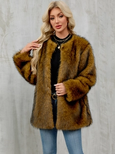 Detail of soft fluffy texture on oversized golden brown faux fur coat for women