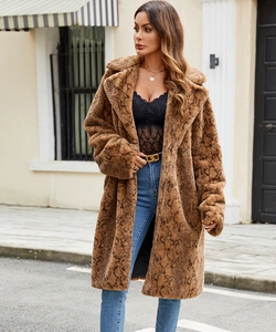 Detail of faux fur coat featuring brown snakeskin pattern with large lapel and texture