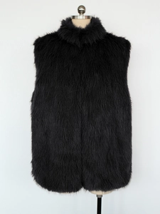 Detailed close-up showing the fluffy texture of the black faux fox fur vest on a mannequin