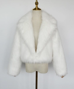 Detail of white faux fur short jacket showing thick plush texture and lapel collar