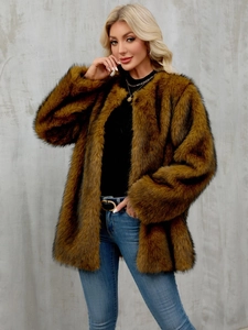 Detail shot of a tan faux fur coat with rich texture and a classic open front style