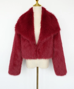 Detail of burgundy faux fur short coat featuring a wide collar and fluffy texture
