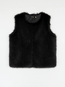 Detail of black faux fur vest showing the inner brand label and soft hair texture