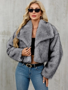 Detailed texture of fluffy grey faux fur coat with oversized lapels in a short style