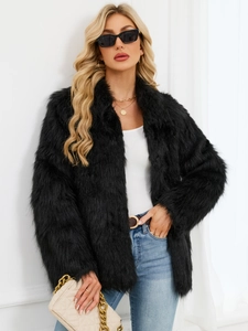Detail of a women's black faux fur jacket with fluffy plush texture and quilted chain bag