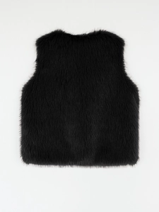 Detailed macro view of high-quality black faux fur vest showing plush and glossy texture