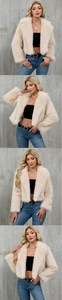 Detailed macro view of plush beige faux fur texture on a cropped open-front jacket
