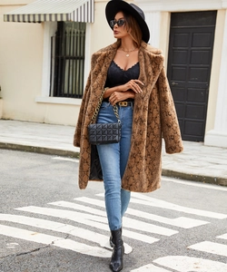 Street style shot of brown snakeskin faux fur coat with black lace top and jeans