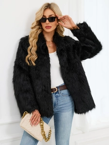Close-up detail of plush black faux fur coat texture and long sleeves on a model