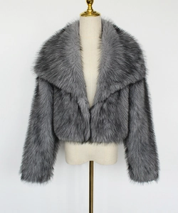 Detailed view of the luxury faux fox fur texture and wide collar on grey winter coat